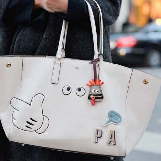 PARIS, FRANCE - MARCH 04: A guest poses with an Anya Hindmarch stickers bag on Day 2 of Paris Fashion Week Womenswear FW 15 on March 4, 2015 in Paris, France. (Photo by Vanni Bassetti/Getty Images)